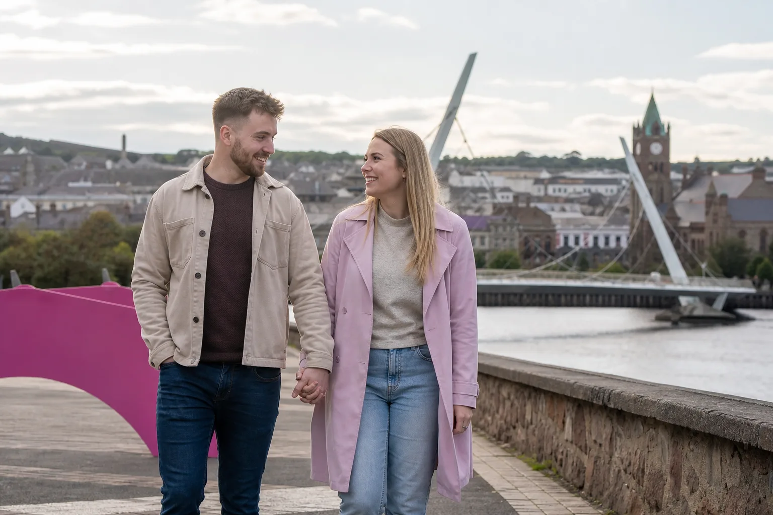 Two people talking over coffee beside the River Foyle in Derry
